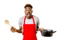 Black afro american man home cook in chef apron cooking pot and Royalty Free Stock Photo