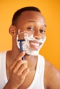 Black afro man shaving his face with the razor blade through shave foam Royalty Free Stock Photo