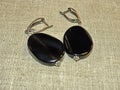 Black agate earrings. Jewelry made of black agate is unusual and has a mystical beauty. Royalty Free Stock Photo