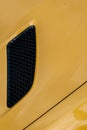 Black air intake grid of yellow sport turbo car Royalty Free Stock Photo
