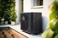 Black Air Source Heat Pumps installed on exterior of house