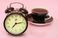 The black alarm clock and black cup from coffee