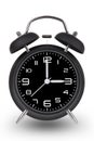 Black alarm clock with hands at 3 am or pm on white bac