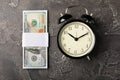 Black alarm clock on money banknotes Dollars, business planning and finance concept. Time is money. Royalty Free Stock Photo