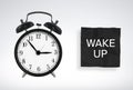 Black alarm clock and paper reminder, WAKE UP. concept of wake up