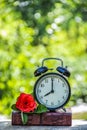 Black alarm clock on a stack of books. Black alarm clock on the window. Morning Concept. Royalty Free Stock Photo