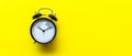 2021 and 2022 on black alarm clock on yellow background. Merry Christmas and Happy new year concept. Royalty Free Stock Photo