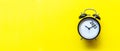 2022 and 2023 on black alarm clock on yellow background, Merry Christmas and Happy new year concept. Royalty Free Stock Photo