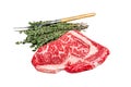 Black Angus Rib Eye steak, raw marbled beef meat with herbs. Dark background. Top view Royalty Free Stock Photo