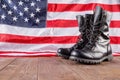 black ankle boots in front of US flag on wooden surface