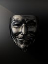 Black anonymous mask on black background