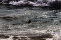 Black anonymous unrecognizable silhouette in a rough sea