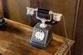 Black antique analog telephone on wooden table