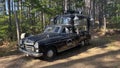 Black, antique car in the exhibition of historic, vintage cars in the countryside