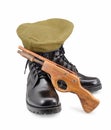 Black army shoes,Beret,gun on white backgrounds Royalty Free Stock Photo