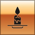 Black Aroma candle icon isolated on gold background. Vector