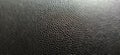 Black artificial leather close-up. Blurred edges of the image. Soft focus Royalty Free Stock Photo