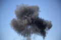 Black artificial smoke in the blue sky Royalty Free Stock Photo