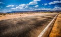 Black asphalt highway with wind gust blowing red sand across inthe northern Arizona desert Royalty Free Stock Photo