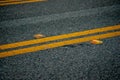 Black asphalt road with yellow lines and orange reflectors Royalty Free Stock Photo