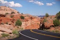 The black asphalt switchbacks surrounded by red rock walls crossing the Capitol Reef National Park Royalty Free Stock Photo