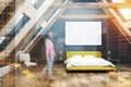 Black attic bedroom interior, yellow bed, girl Royalty Free Stock Photo