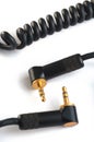 Black audio cable with two gold stereo plugs 3,5mm isolated on w Royalty Free Stock Photo