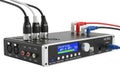 Black audio converter device with multiple input and output ports, including xlr and rca connections, displaying conversion status Royalty Free Stock Photo