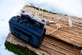 Black audio player with a cassette on a wooden piece in the snow Royalty Free Stock Photo