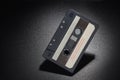 Black audio tape compact cassette on black background Royalty Free Stock Photo
