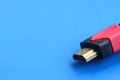 Black audio video HDMI computer cable on blue background. Close Royalty Free Stock Photo