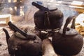 Black authentic teapots on fire Royalty Free Stock Photo