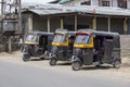 Black auto rickshaw taxis on a road in Srinagar, Kashmir, India