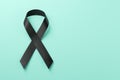 Black awareness ribbon on blue background. Mourning and melanoma symbol