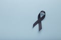 Black awareness ribbon Isolated on blue background