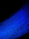 Black background with blue abstract striped texture in brush stroke paint design that is vibrant and colorful Royalty Free Stock Photo