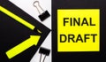 On a black background, a bright yellow pencil and an arrow and a yellow sheet of paper with the text FINAL DRAFT Royalty Free Stock Photo