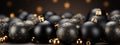 Black Background with Black Christmas Balls and a Swirl of Golden Glitter to Create Festive Atmosphere...Refined Frame on Black Royalty Free Stock Photo