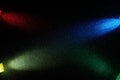 On a black background, crossed oncoming short beams of blue red green and yellow gradient light Royalty Free Stock Photo