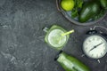 On a black background, cucumber smoothie and ingredients. Flat lay with copy space. Healthy breakfast of green Royalty Free Stock Photo
