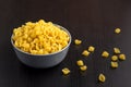 black background with italian raw conchiglie paste shells in bowl with copy space