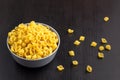 black background with italian raw conchiglie paste shells in bowl with copy space