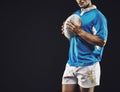 Black background, man and ball for rugby sport, closeup and mockup space, sportswear and professional for workout. Male Royalty Free Stock Photo