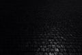 Black background. Old cobblestone pavement in perspective. Abstract background. Royalty Free Stock Photo