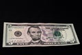 On the black background is one bill in size five dollars Royalty Free Stock Photo