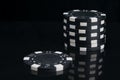 On a black background with reflection, close-up of blackjack chips