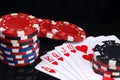 On a black background with a reflection, close-up,is a high alignment of cards for poker, street and colored chips Royalty Free Stock Photo