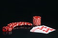 On a black background, with reflection, red chips and dice, near the alignment in poker, street Royalty Free Stock Photo