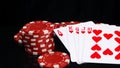 On a black background with reflection, red chips and a winning hand, in poker, close-up Royalty Free Stock Photo