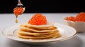 Russian pancakes with red caviar on white table